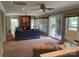 Spacious living room with a brick fireplace, large windows, and access to the patio at 24756 Strand Dr, Albemarle, NC 28001
