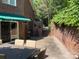 Outdoor seating area off a brick home with a patio, table, and access to brick walking paths at 24756 Strand Dr, Albemarle, NC 28001