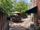 Comfortable patio seating with an umbrella and lush landscaping; great for entertaining at 24756 Strand Dr, Albemarle, NC 28001
