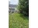 A spacious backyard features a well-maintained lawn, landscaping, and the rear view of the home at 4016 Holly Villa Cir, Indian Trail, NC 28079