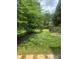 Spacious backyard featuring lush green grass, mature trees, and a wooden fence, creating a serene outdoor space at 4016 Holly Villa Cir, Indian Trail, NC 28079