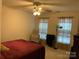 Bright bedroom with a ceiling fan, carpeted floors, and windows dressed in lace curtains at 4016 Holly Villa Cir, Indian Trail, NC 28079
