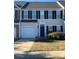 Charming townhouse featuring black shutters and a one-car garage for convenient parking at 4016 Holly Villa Cir, Indian Trail, NC 28079