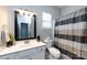 Cozy bathroom featuring a white vanity, toilet, framed mirror, and tiled shower with a curtain at 1041 Kensrowe Ln, Matthews, NC 28104