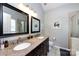 Bright bathroom features double sinks with granite countertops and a tile surround shower at 1041 Kensrowe Ln, Matthews, NC 28104