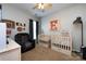 Cozy Bedroom with two cribs, basketball decor, chair, and neutral colors to create a relaxing space at 1041 Kensrowe Ln, Matthews, NC 28104