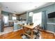 Dining room featuring a light fixture and open to the kitchen with views of the stainless steel refrigerator at 1041 Kensrowe Ln, Matthews, NC 28104