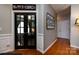 Inviting hallway with hardwood floors and decorative wall art, showcasing the home's charm at 1041 Kensrowe Ln, Matthews, NC 28104