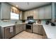 Kitchen with stainless steel appliances, tile backsplash, white countertops, and tile flooring at 1041 Kensrowe Ln, Matthews, NC 28104