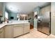 Kitchen featuring stainless steel refrigerator, white countertops and views into the dining room at 1041 Kensrowe Ln, Matthews, NC 28104