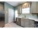 Kitchen with stainless steel appliances, white countertops, pantry door and view to the backyard at 1041 Kensrowe Ln, Matthews, NC 28104