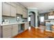 Kitchen featuring white countertops, wood floors, view of stainless steel refrigerator and pantry at 1041 Kensrowe Ln, Matthews, NC 28104