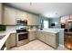 Kitchen featuring stainless steel appliances, white countertops, and a view into the living room at 1041 Kensrowe Ln, Matthews, NC 28104