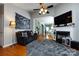 Spacious living room with a fireplace, hardwood flooring, and views into the kitchen at 1041 Kensrowe Ln, Matthews, NC 28104