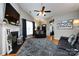 Inviting living room with a fireplace, ceiling fan, and modern decor, creating a cozy ambiance at 1041 Kensrowe Ln, Matthews, NC 28104