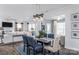 Open-concept dining room featuring a modern light fixture, stylish decor, and connection to the living area at 1290 Kindness Nw Ct, Concord, NC 28027