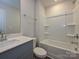 Bathroom with a bathtub, shower, and grey vanity at 1620 Village Grove Ln, Monroe, NC 28110