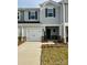 Two-story house with gray siding, white garage door, and landscaping at 1620 Village Grove Ln, Monroe, NC 28110