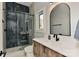 Modern bathroom with dark-tiled shower, floating vanity, and arched mirror at 569 Evergreen Rd, Clover, SC 29710