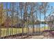 Scenic backyard view of a peaceful lake and tree line at 569 Evergreen Rd, Clover, SC 29710