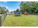 Large backyard with trampoline, playset, and green grass perfect for outdoor fun at 7686 Hickory Creek Dr, Denver, NC 28037
