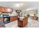Well-lit kitchen with a center island, wood cabinets and stainless steel appliances at 7686 Hickory Creek Dr, Denver, NC 28037