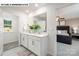 Well-lit bathroom features a double vanity, a large mirror, and stylish fixtures, plus a door to the bedroom at 107 Rustling Waters Dr, Mooresville, NC 28117