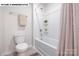 Neat bathroom features a shower-tub combo with neutral accents and a tile floor at 107 Rustling Waters Dr, Mooresville, NC 28117
