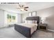 Spacious bedroom with a plush carpet, ceiling fan, and a large window offering ample natural light at 107 Rustling Waters Dr, Mooresville, NC 28117