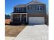 Charming two-story home with a welcoming front porch and a spacious two car garage at 107 Rustling Waters Dr, Mooresville, NC 28117