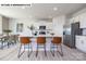 Bright kitchen featuring white cabinetry, stainless steel appliances, and a center island with bar stools at 107 Rustling Waters Dr, Mooresville, NC 28117