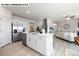 Spacious kitchen with island, stainless steel appliances, and open floor plan to living area at 107 Rustling Waters Dr, Mooresville, NC 28117