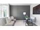 Cozy home office with a gray accent wall, comfortable seating, and a glass-top desk with a periodic table art piece at 116 Rustling Waters Dr, Mooresville, NC 28117