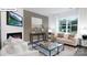 Cozy living room featuring a fireplace, gray walls, and a large window at 116 Rustling Waters Dr, Mooresville, NC 28117