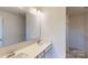 Bathroom with double sinks, a large mirror, and marble flooring at 4057 Lawnview Dr, Charlotte, NC 28269