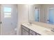 Bright bathroom featuring a large mirror, vanity, and a window at 4057 Lawnview Dr, Charlotte, NC 28269