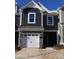 Modern two-story townhome with gray siding, stone accents, and a two-car garage at 4057 Lawnview Dr, Charlotte, NC 28269
