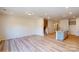 Spacious living room with light wood floors connects to the staircase and kitchen area at 4057 Lawnview Dr, Charlotte, NC 28269