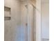 Modern shower with a glass door and neutral-colored tile surround at 4057 Lawnview Dr, Charlotte, NC 28269