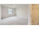 Bright bedroom with neutral carpet and a window at 9753 Inkberry Dr, Gastonia, NC 28056