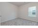 Simple bedroom with neutral walls and grey carpeting at 1209 Red River Dr, Salisbury, NC 28144
