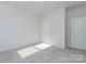 Well-lit bedroom featuring neutral walls and grey carpeting at 1209 Red River Dr, Salisbury, NC 28144