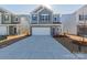 Charming two-story home with a two-car garage, gray door and blue siding at 1209 Red River Dr, Salisbury, NC 28144