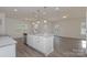 Modern kitchen with white cabinets, granite countertops, and an island at 1209 Red River Dr, Salisbury, NC 28144