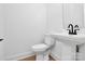 Modern bathroom with a pedestal sink, sleek fixtures and light wood-look flooring at 2059 Parks Rd, Salisbury, NC 28147