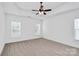 Spacious bedroom featuring neutral carpet, ceiling fan, and plenty of natural light from two windows at 2059 Parks Rd, Salisbury, NC 28147