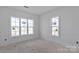 Bright room with two windows and bare floors, still awaiting finishing touches at 2059 Parks Rd, Salisbury, NC 28147