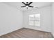 Bright bedroom with neutral carpet, a ceiling fan, and large window with blinds at 2059 Parks Rd, Salisbury, NC 28147