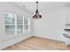 Bright dining area features a modern chandelier and large window, perfect for entertaining at 2059 Parks Rd, Salisbury, NC 28147