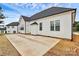 New home featuring white siding, black trim and a concrete patio, set against a blue sky at 2059 Parks Rd, Salisbury, NC 28147